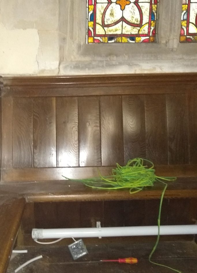 Part way through installing a heater in a church pew